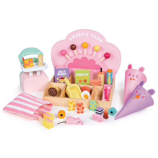 Toy sweet shop set with various items on a white background