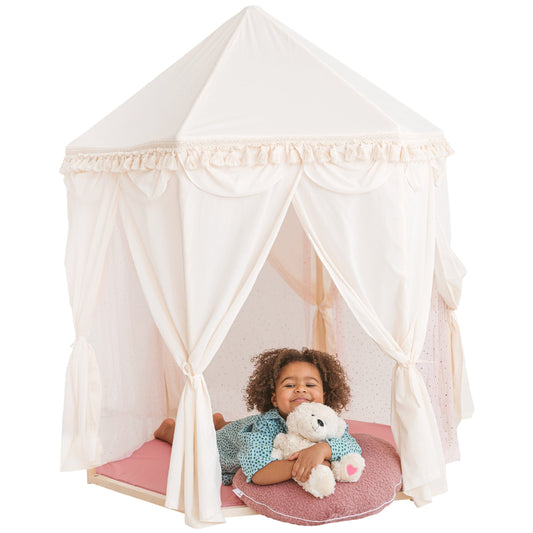 Child sitting inside a white play tent with a teddy bear, on a white background